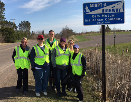 RAM volunteers in front of adopt a hwy sign